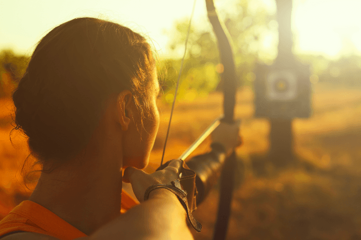 woman aiming bow