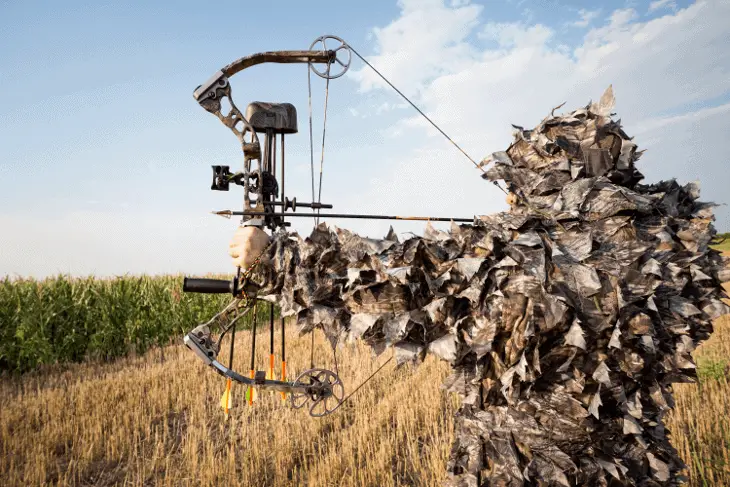 hunter holding compound bow