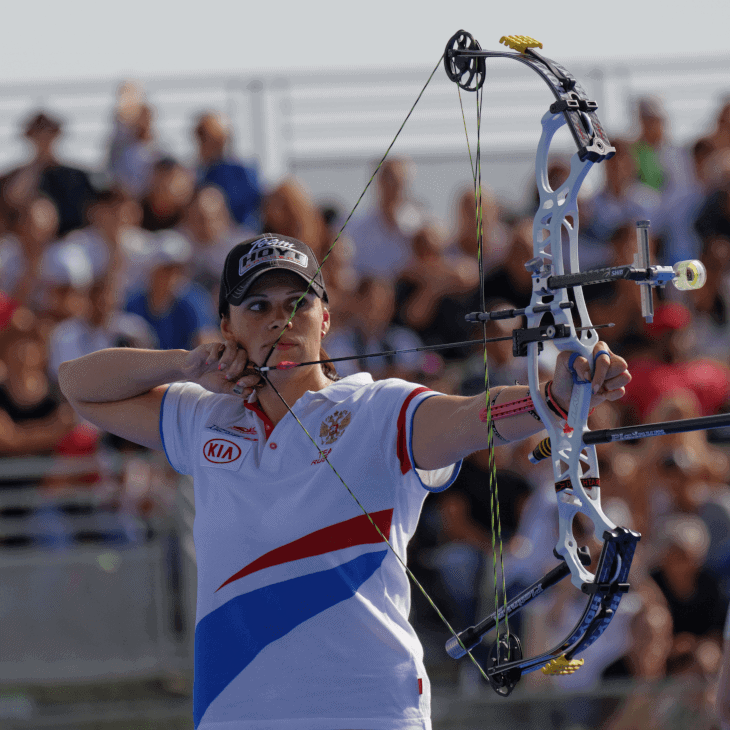 woman firing compound bow