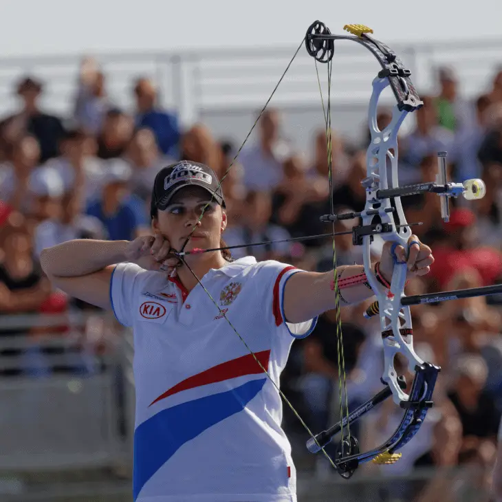 woman target shooting with compound bow