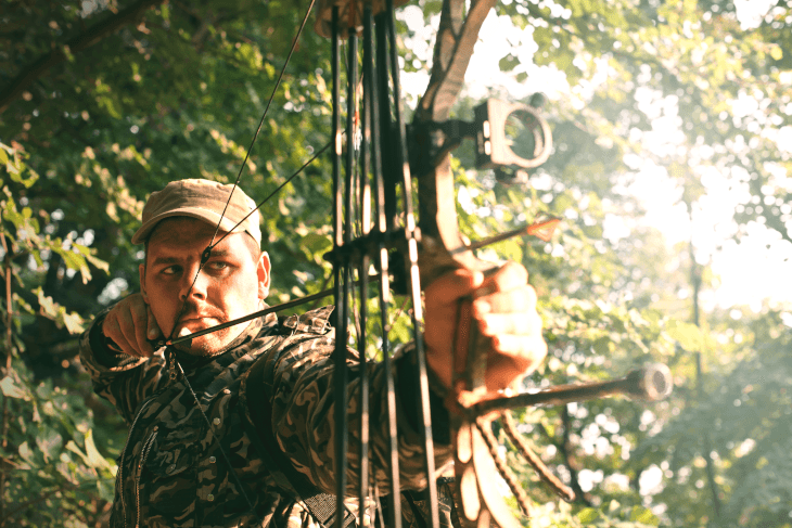 bow hunter aiming