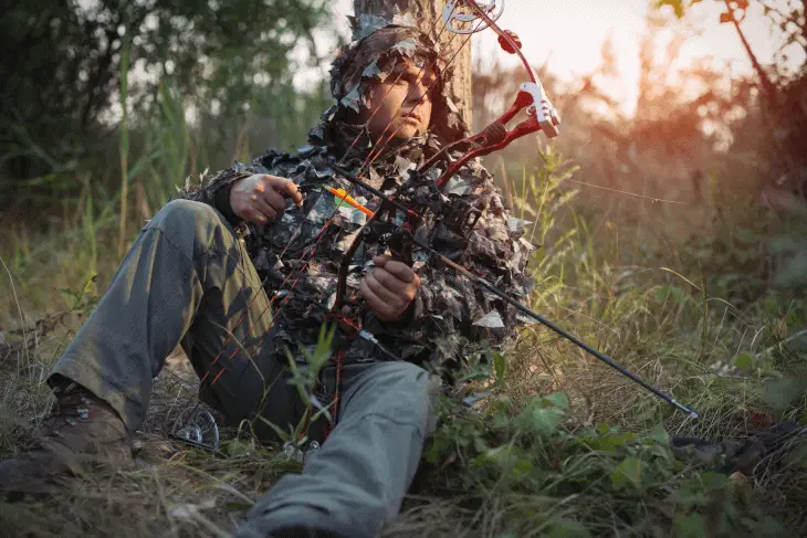 Hunter in Camo Behind Tree